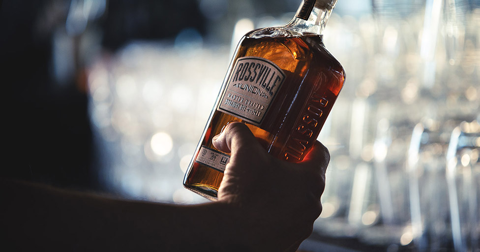 Hand holding Rossville Union Whiskey