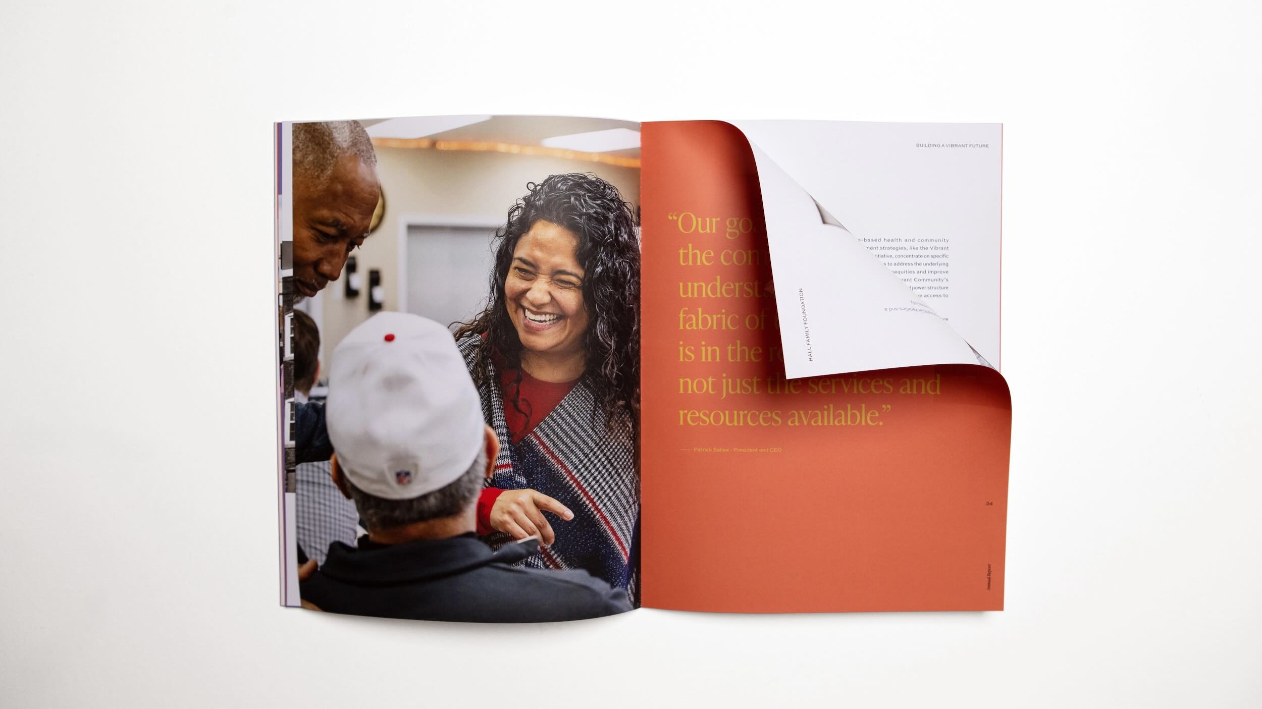 Hall Family Foundation's 2023 annual report open to a dog-eared page with a woman smiling