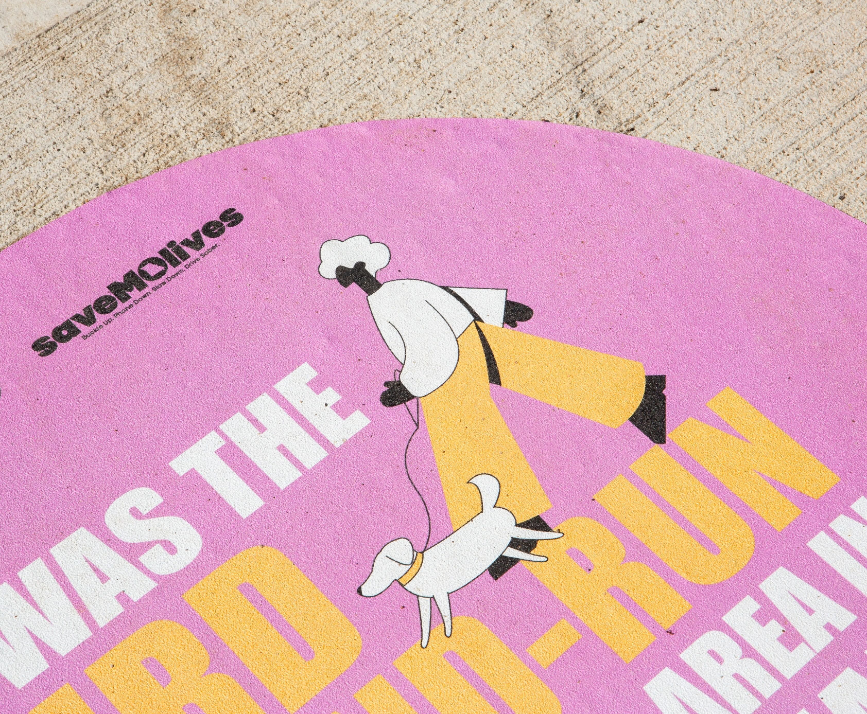 Closeup of sidewalk decal with illustration of woman walking a dog
