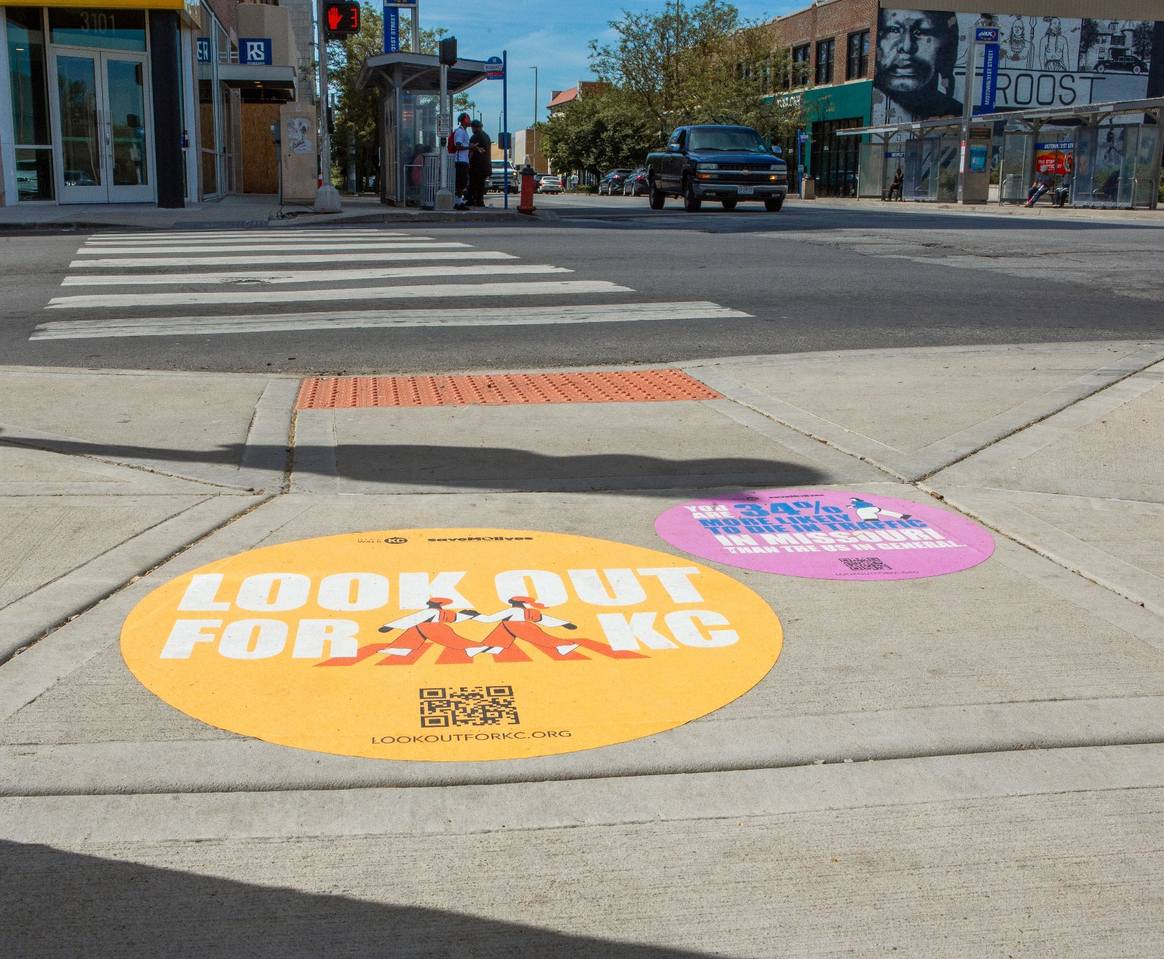 Kansas City intersection with sidewalk decals promoting Look Out for KC campaign