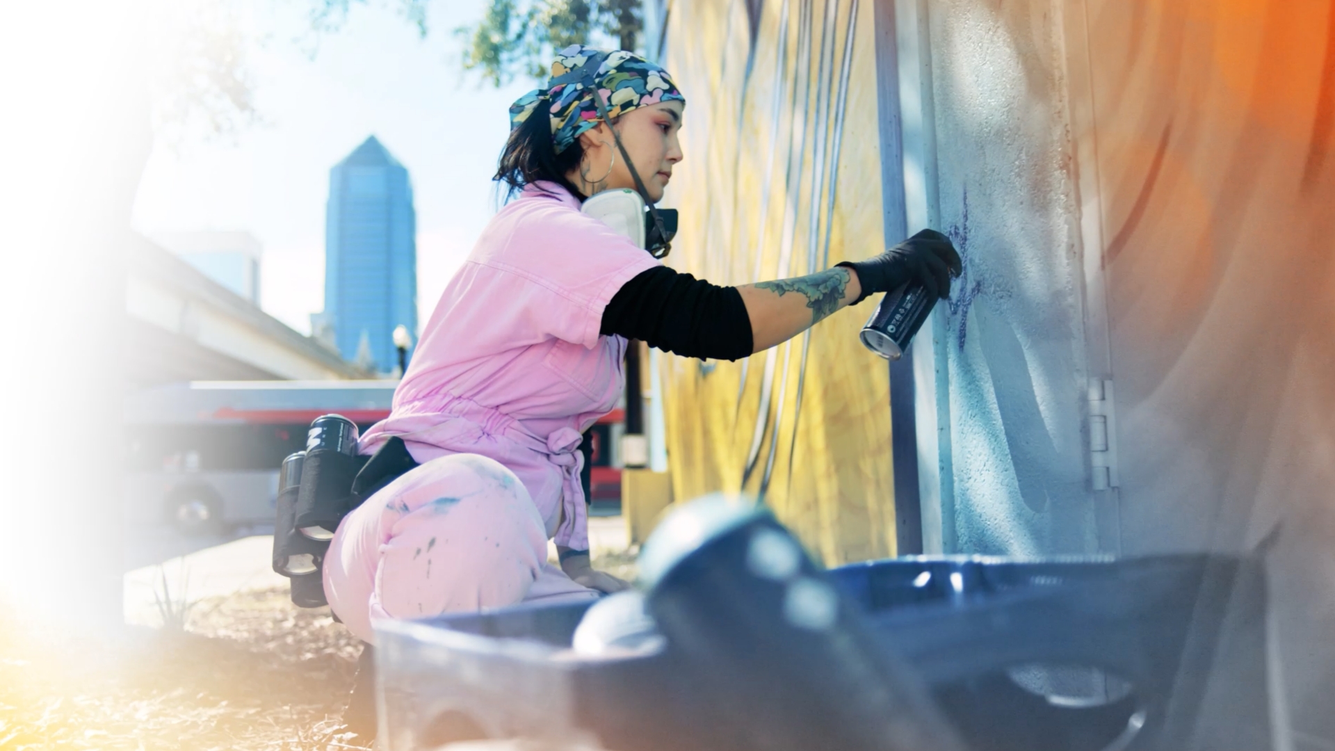 Woman spray painting a mural