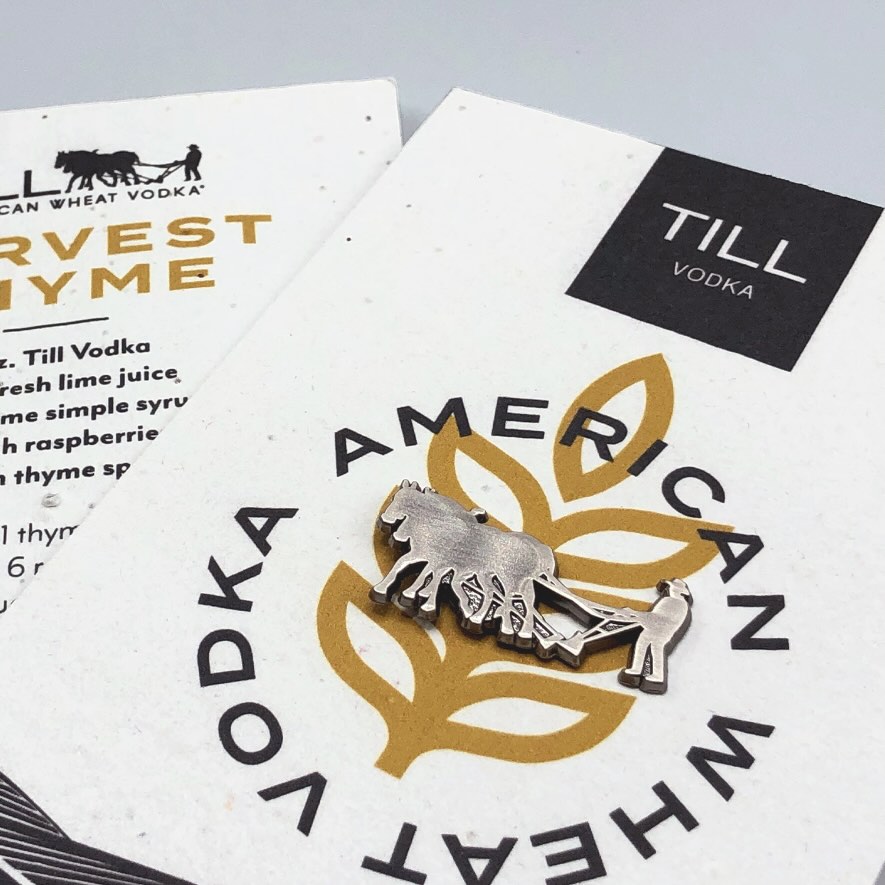 Closeup of Till Vodka lapel pin