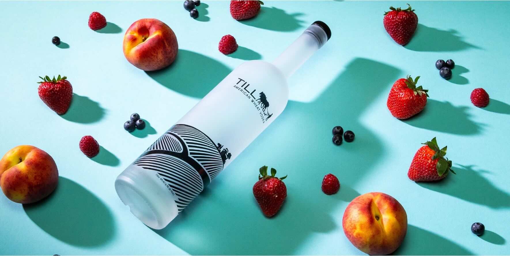Till Vodka bottle surrounded by fruit