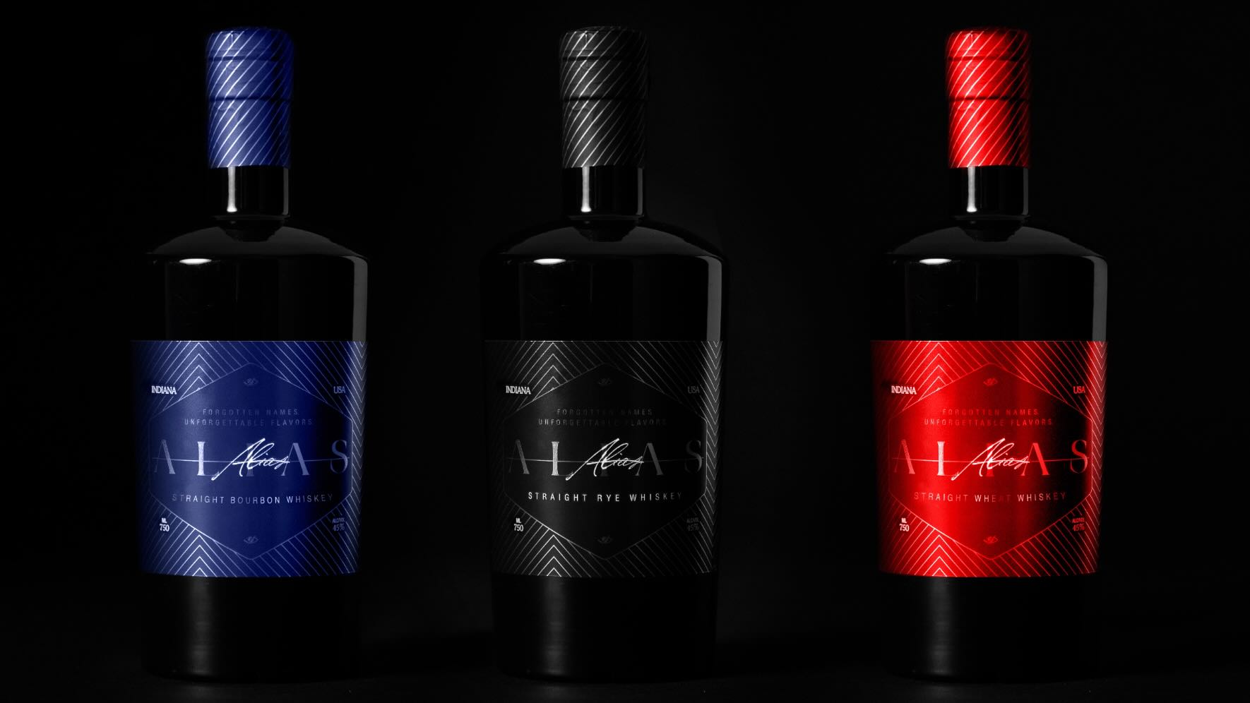 Blue, Black, and Red bottles of Alias Whiskey