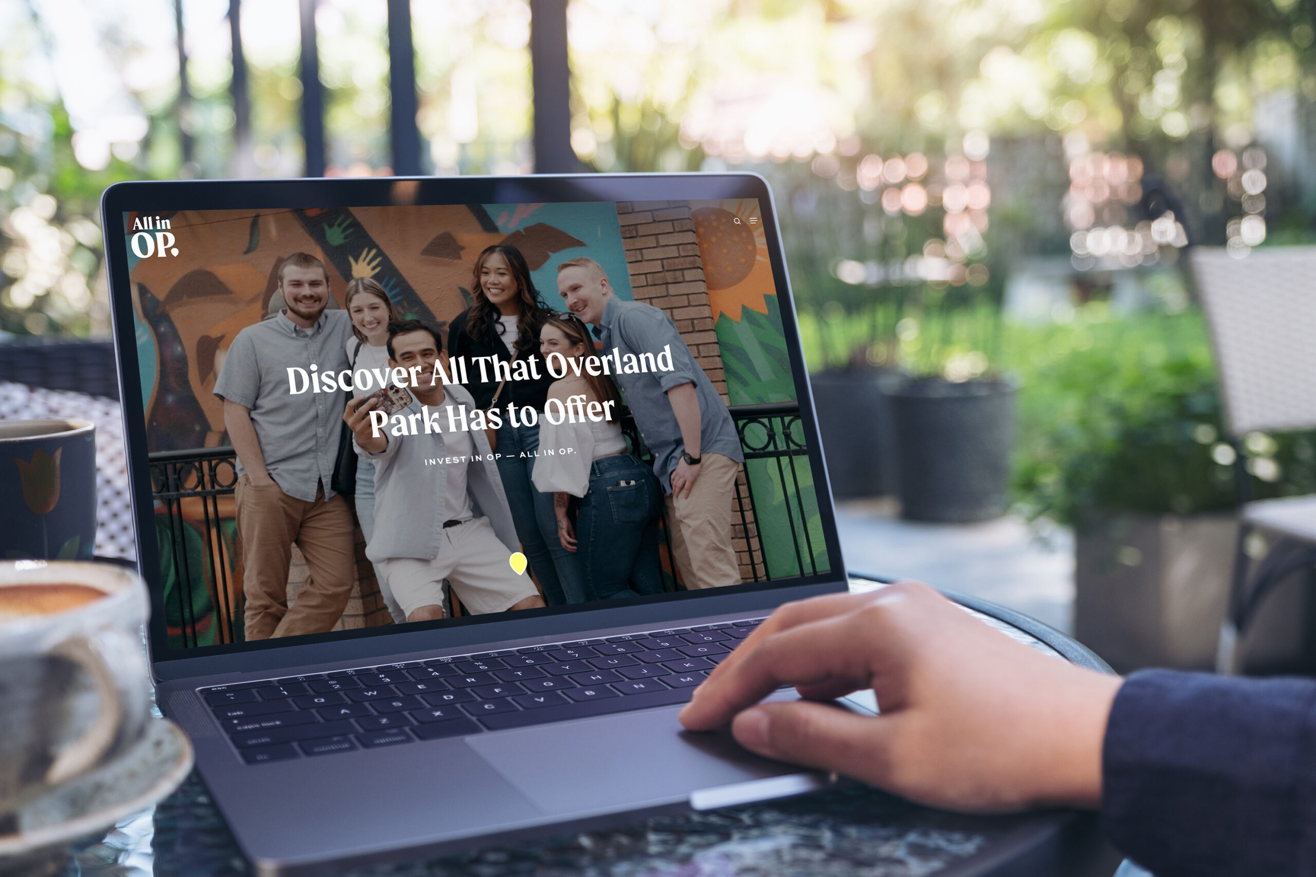 Person exploring allinoverlandpark.com on a laptop