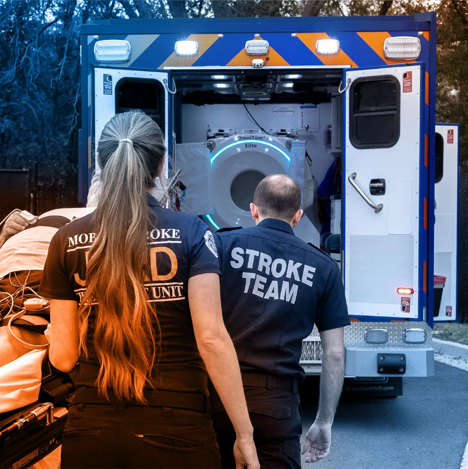 UF health stroke team pushing patient on stretcher into emergency vehicle